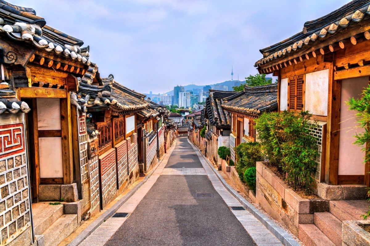 Traditional Korean neighborhood and modern cityscape